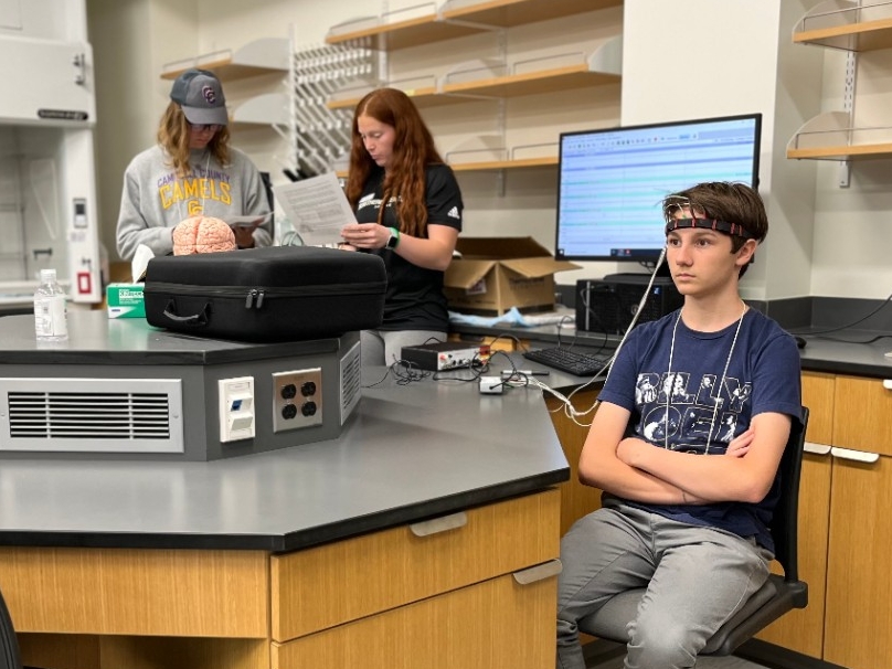 High school aged students doing neuroscience experiments in the lab