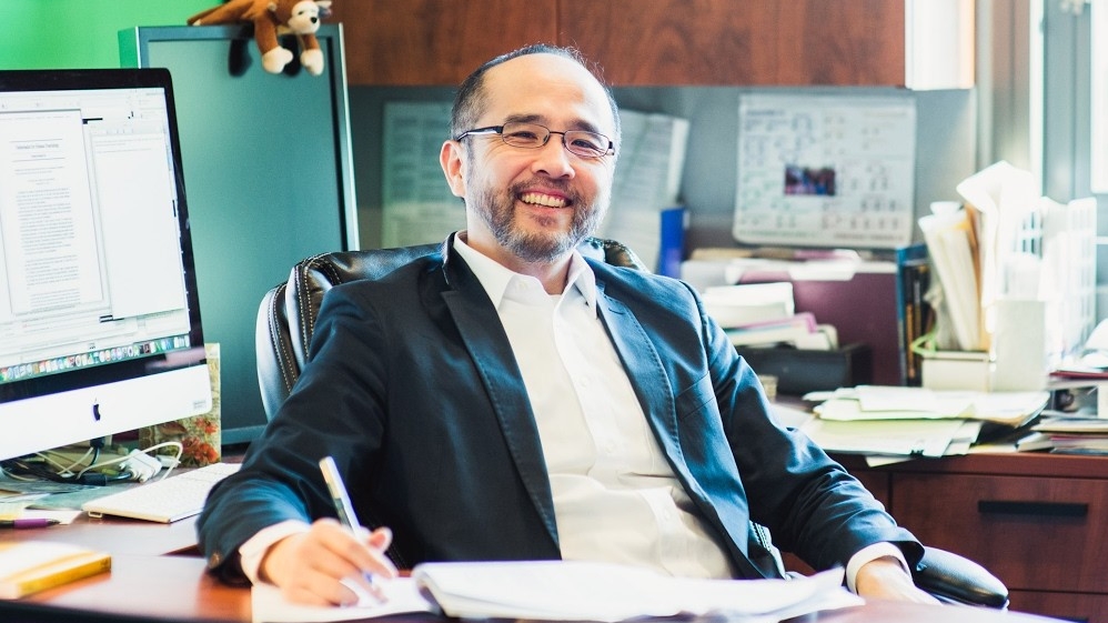 Image of guest speaker, Francis Su, in his office