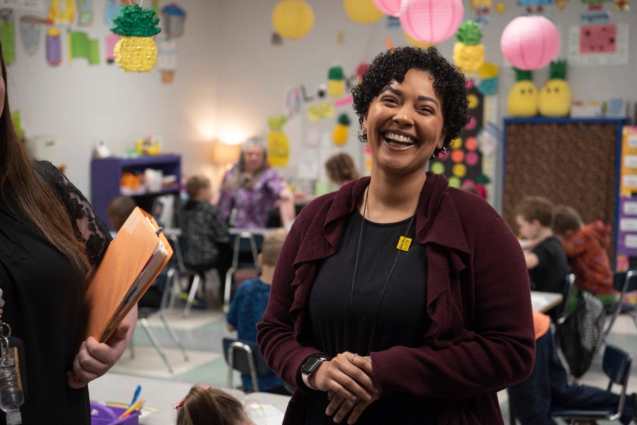Young female educator smiling in a classroom