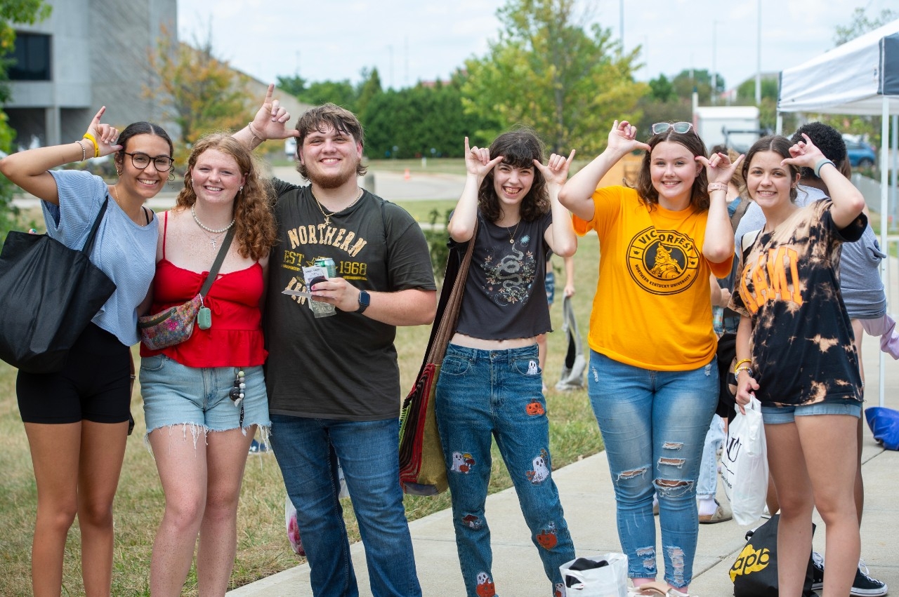Group of six students giving a Norse-Up salute.