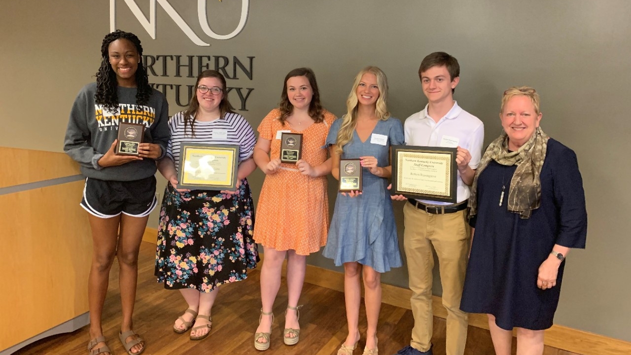 Students holding their scholarship awards