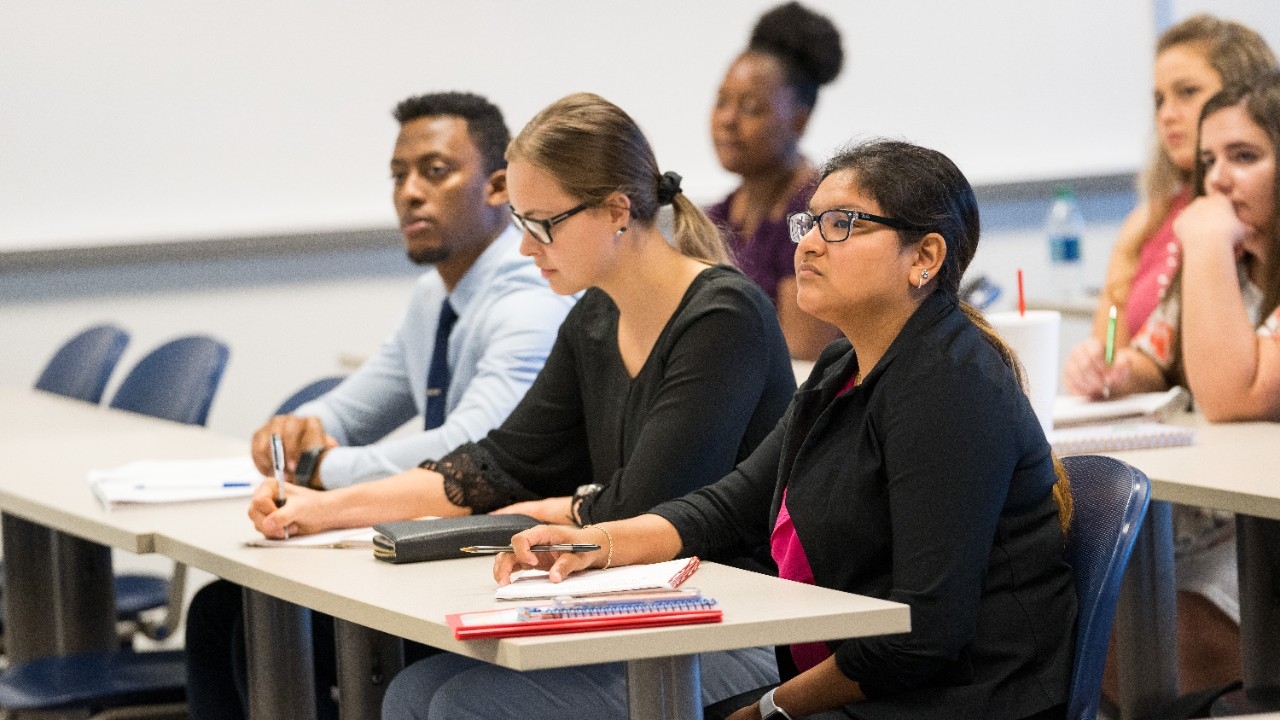 Students listen to a lecture in the College of Business