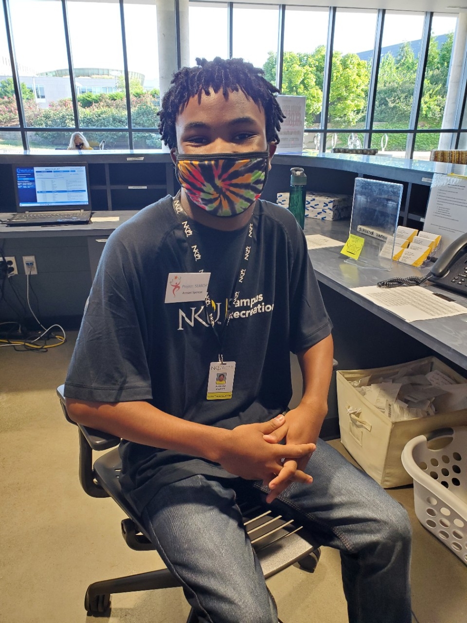 Project Search Intern sitting at front desk in campus rec center