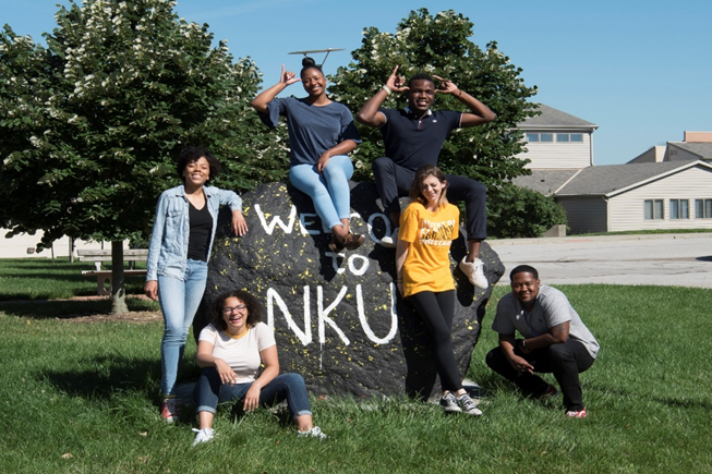 students gathered around NKU rock
